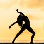 silhouette of woman making yoga pose