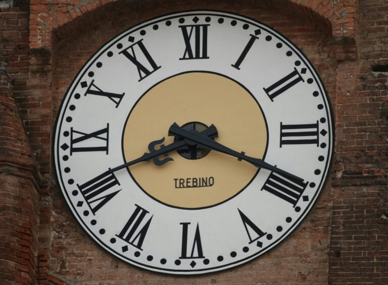 A clock with roman numerals on a brick wall