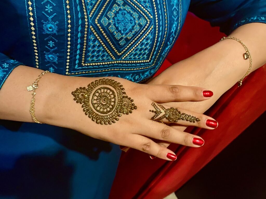 a woman's hand with henna tattoos on it