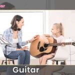 A Girl is Learning Guitar from her Tutor